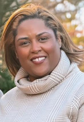 portrait of Sherena Angela Black with trees in the background.