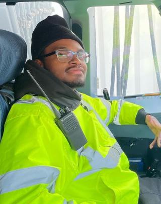 photo of Marven Gauvin in a high-visibility jacket, sitting in a vehicle