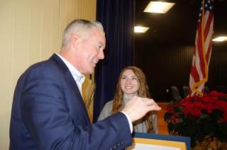 photo of male guest congratulating students