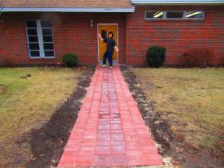 Photo of Brendan Todd at the memorial walkway he constructed at Holbrook United Methodist Church