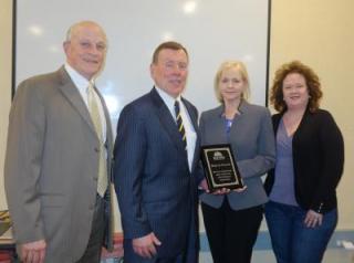photo of Charles Gisondi, Stephen P. Costello, Paula Burke, and Marybeth Nearen holding a plaque