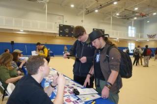 photo of students at a table set up at the Credit for Life fair
