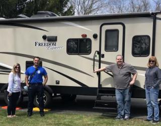 photo of Kelli Jardin, David Jardin, Chris Deady, and Sue Deady standing in front of Chris Deady's RV