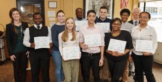 group photo of students holding their various awards and certificates