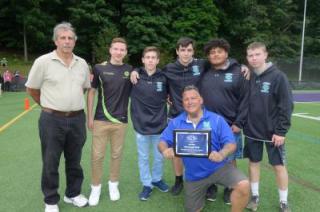 photo of student athletes and coaches presenting their award