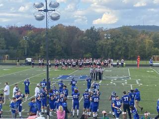 Wide shot of the Blue Hills football team taking the field against Diman Regional Vocational Technical High School.