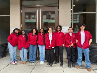 group photo of the Blue Hills SkillsUSA Leadership team standing outside the entrance to the Ronald McDonald house